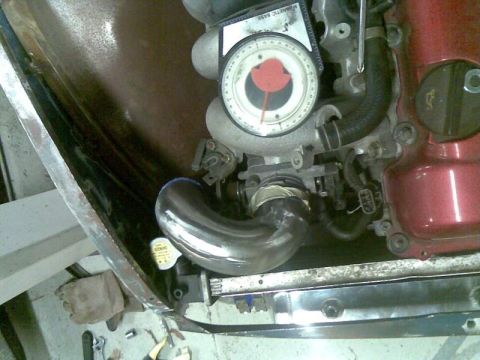 1969 MINI Cooper - Custom intercooler piping is installed on an engine, with a gauge visible on the intake manifold.