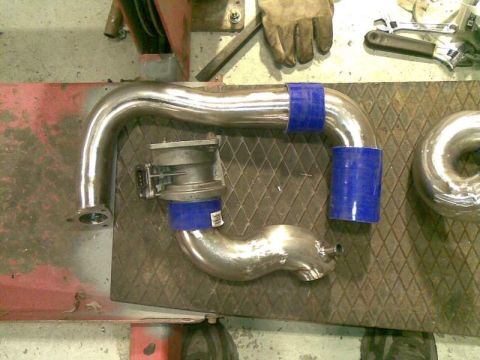 1969 MINI Cooper - Custom intercooler piping and throttle body assembly laid out on a workbench.