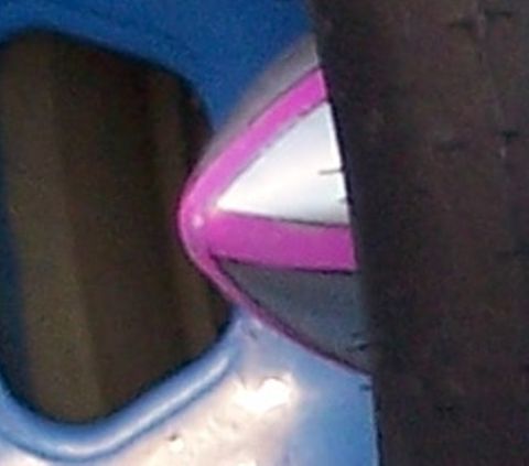 1971 Ford Ranchero - A close-up of chrome trim with a pink stripe is visible against a blue background.