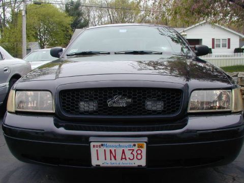 2003 Ford Crown Victoria - Front view of a black 2003 Ford Crown Victoria, a custom grille and Massachusetts license plate.
