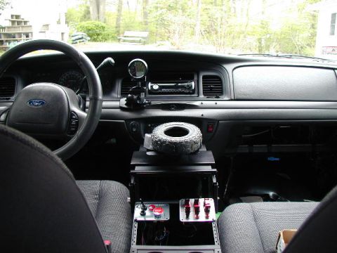 2003 Ford Crown Victoria - The interior of a 2003 Ford Crown Victoria, viewed from the passenger seat, reveals the dashboard, steering wheel, and center console modif…