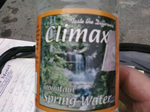 1985 Ford LTD Crown Victoria - A bottle of Climax Mountain Spring Water is held up, with a waterfall scene on its label.