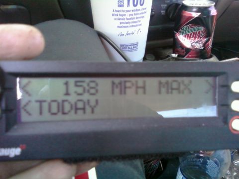 2000 Mercury Grand Marquis - A digital gauge shows a maximum speed of 158 MPH, with a can of Mountain Dew and a cup visible behind it.