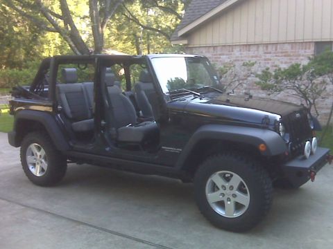 2008 Jeep Wrangler - This Jeep Wrangler has its doors and roof off, showing the interior seats and roll cage.