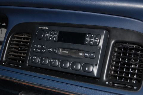1985 Mercury Grand Marquis - Close-up of a car's dashboard, focusing on the radio and air conditioning vents.