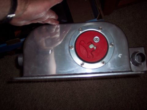 1971 Ford Mustang - This aluminum fuel tank features a red cap with a twist-lock mechanism and a metal fitting on the side.