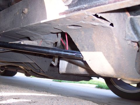1971 Ford Mustang - Close-up view of a vehicle's undercarriage, showing suspension parts and wiring.