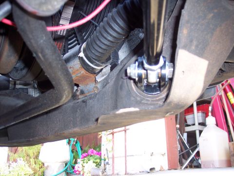 1971 Ford Mustang - Detail of a vehicle's suspension linkage, showing a ribbed hose and fan belts, likely part of an engine bay.