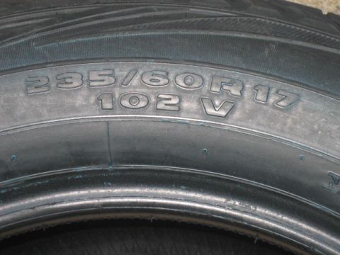 1996 Ford Thunderbird - The tire sidewall displays its size and load rating, indicating it is a part, not a vehicle.