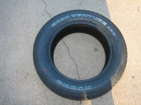 1996 Ford Thunderbird - A Kumho Road Venture APT tire is shown lying on a concrete surface.