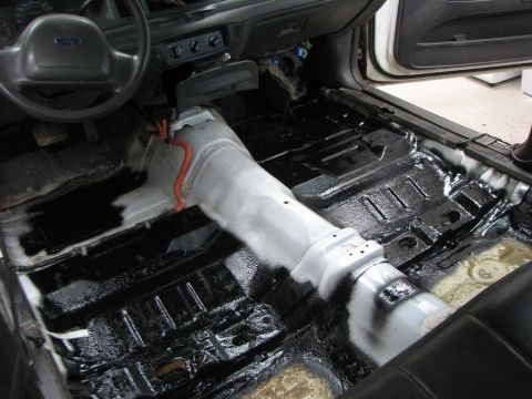 2003 Ford Crown Victoria - The interior of a 2003 Ford Crown Victoria is shown with the floor removed, likely for an audio system upgrade.