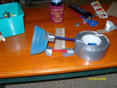 1989 Ford Bronco - A homemade device made with duct tape, a blue plastic funnel, and straws is assembled on a wooden table.