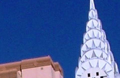 1971 Ford Ranchero - The iconic spire of the Chrysler Building stands tall against a clear blue sky, with a "SUPERMOTORS" watermark visible at the bottom.