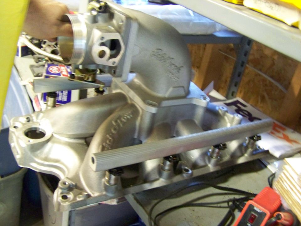 Edelbrock aluminum intake manifold with fuel rail on a workbench