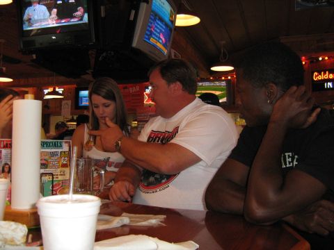 1993 Ford Bronco - People are gathered at a bar, with televisions displaying sports and games in the background.