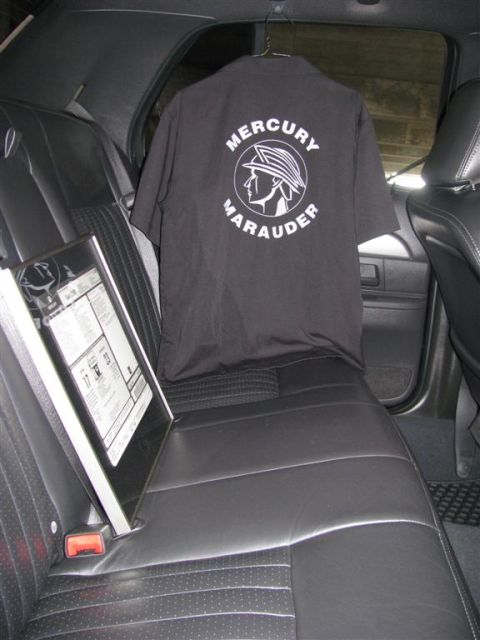 2003 Mercury Marauder - A t-shirt and window sticker are displayed on the back seat of a car.