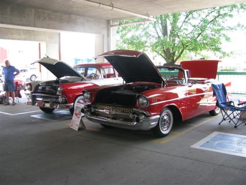 2003 Mercury Marauder - Two vintage American cars, a convertible and a station wagon, are displayed with their hoods open at an outdoor event.