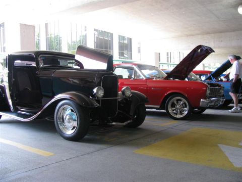 2003 Mercury Marauder - Several cars are parked under a covered area, with hoods open.