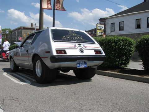 2003 Mercury Marauder - A silver AMC Gremlin is parked in a lot with a Pepsi sign visible in the background.