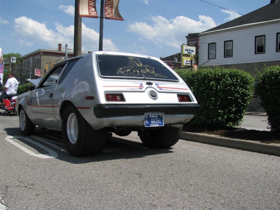 Silver AMC Gremlin with wide rear tires and a custom decal on the rear window