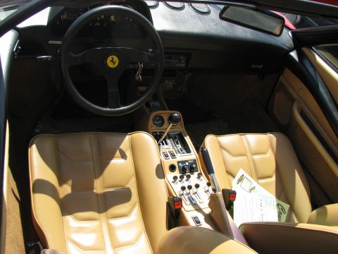 2003 Mercury Marauder - Car interior shows tan leather seats, steering wheel, and center console with many buttons and switches.