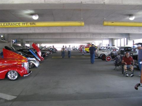 2003 Mercury Marauder - A variety of vehicles are on display at an indoor car show, with several hoods open for viewing.