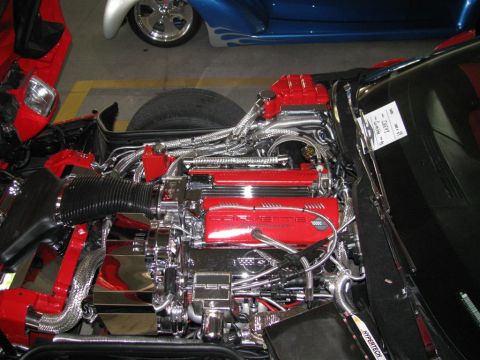 2003 Mercury Marauder - Customized Corvette engine bay at a car show, with another vehicle in the background.