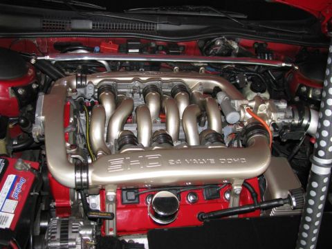 2003 Mercury Marauder - Close-up view of a V8 engine bay, showing the intake manifold, engine block, and battery.