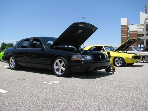 2003 Mercury Marauder - A black 2003 Mercury Marauder is parked at an outdoor event with its hood up.