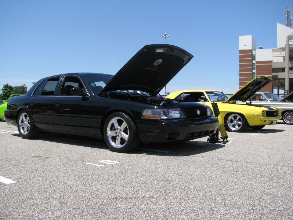 2003 Mercury Marauder with hood open, parked next to a yellow car