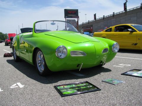2003 Mercury Marauder - A bright green convertible is displayed at a car show with other vehicles and signage in the background.