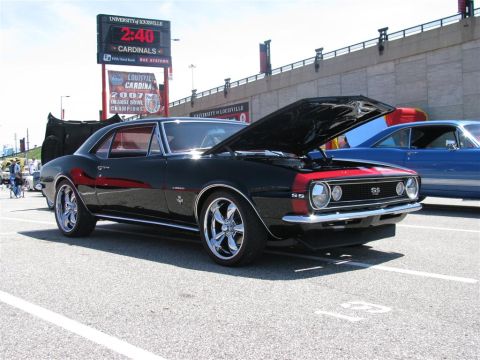 2003 Mercury Marauder - A black and red 1967 Chevrolet Camaro SS is displayed with its hood open at a car show.