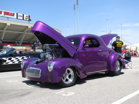2003 Mercury Marauder - A custom purple coupe with its hood open is displayed at an outdoor event.