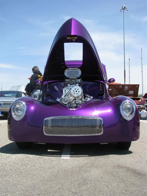 2003 Mercury Marauder - A custom purple hot rod is displayed with its hood and engine exposed at an outdoor car show.