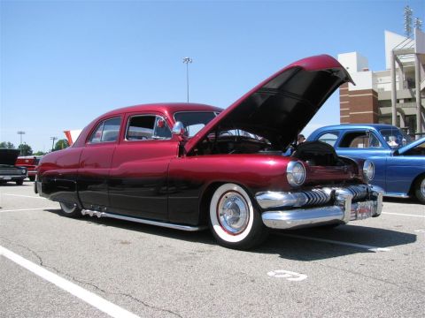 2003 Mercury Marauder - Two classic sedans are parked side-by-side with their hoods open at an outdoor event.