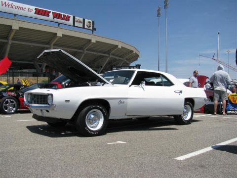 2003 Mercury Marauder - A white 1969 Chevrolet Camaro is displayed with its hood up at an outdoor event.