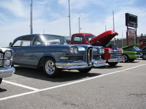 2003 Mercury Marauder - A line of vintage vehicles are parked in an outdoor lot under a bright, cloudy sky.