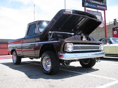 2003 Mercury Marauder - A brown 1964 Chevrolet C10 pickup truck is displayed with its hood open at an outdoor event.