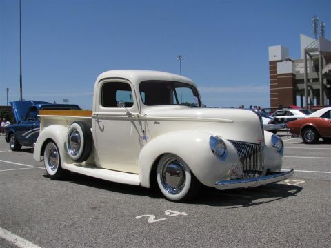 2003 Mercury Marauder - A classic 1940 Ford pickup truck is parked at an outdoor event with other vehicles visible.