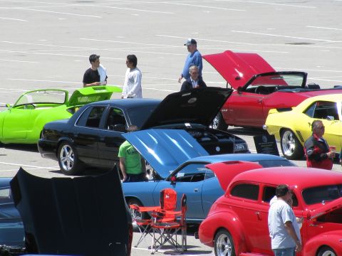 2003 Mercury Marauder - Several cars are displayed at an outdoor event, with attendees examining them.