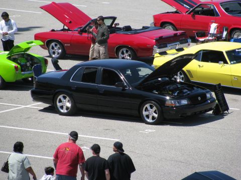 2003 Mercury Marauder - A black 2003 Mercury Marauder is displayed with its hood open at a car show, surrounded by other vehicles.