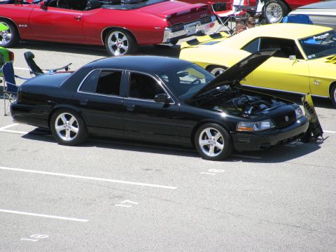2003 Mercury Marauder - Black 2003 Mercury Marauder at a car show with its hood open, other vehicles visible.