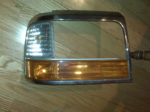 1995 Ford Bronco - Headlight and amber turn signal assembly with chrome trim, likely for an older truck or SUV.