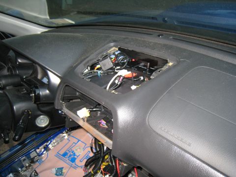2007 Subaru Impreza - The dashboard of a car is disassembled, revealing exposed wires and electronic components.