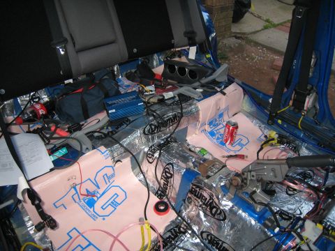 2007 Subaru Impreza - Car interior undergoing sound dampening and wiring installation for an audio system upgrade.
