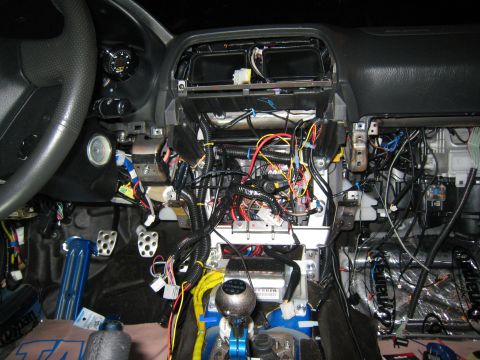 2007 Subaru Impreza - The dashboard of a car has been disassembled, revealing a complex network of wires and electronic components.