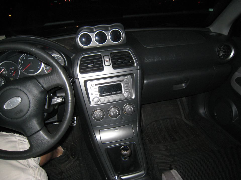 2007 Subaru Impreza interior showing dashboard, steering wheel, and center console with gauges