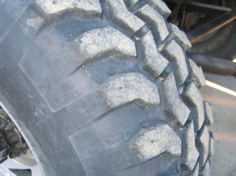 1962 Toyota Land Cruiser - Close-up view of the aggressive tread pattern on an off-road tire.