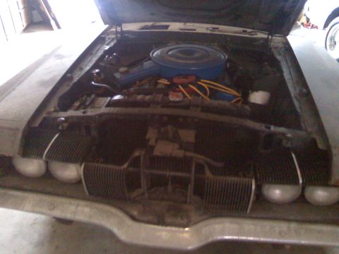 2006 Ford E350 - Engine bay view with hood open, showing the air cleaner and spark plug wires.