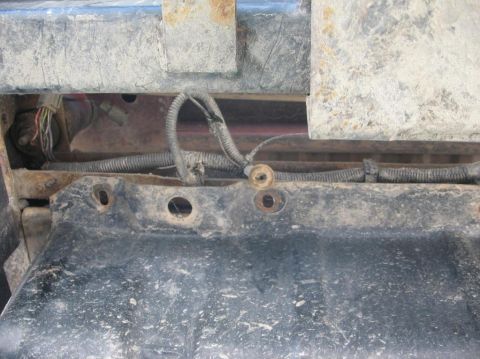 1987 Ford Bronco - Close-up of the fuel pump assembly on a 1987 Ford Bronco, showing wiring and mounting points.